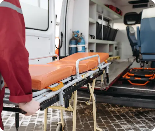 Medical professional with stretcher and ambulance